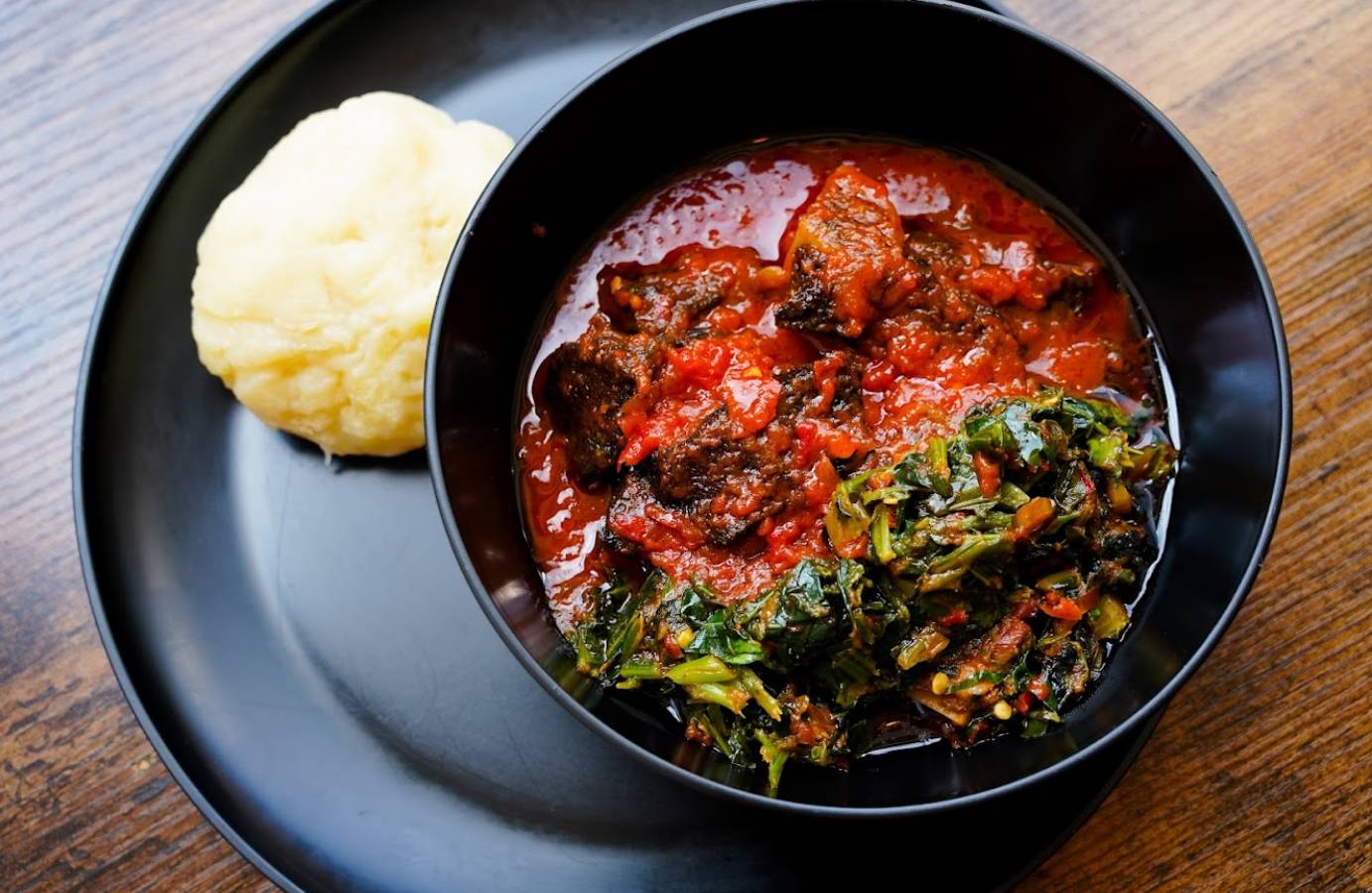 Top view of a Nigerian beef dish with mashed potatoes on the side